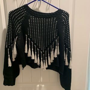 Cropped, tasseled sweater.